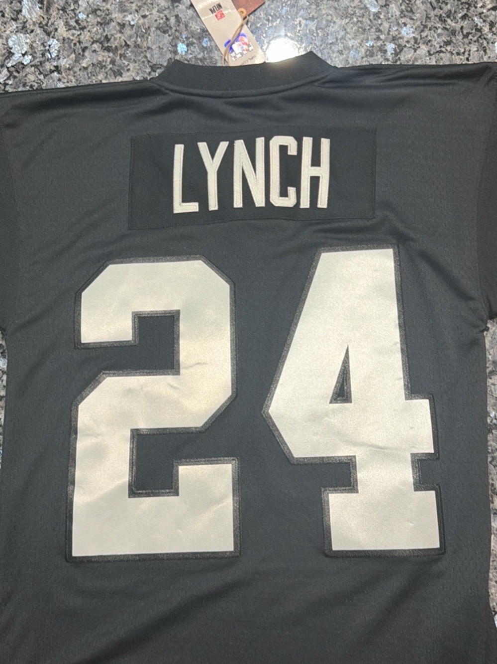 Mitchell & Ness Black Jersey with 'Lynch' and Silver 24